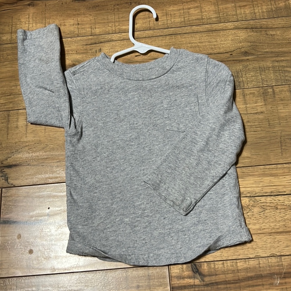 Cherokee 18M grey long sleeve, with a little pocket on the front. Thin and soft